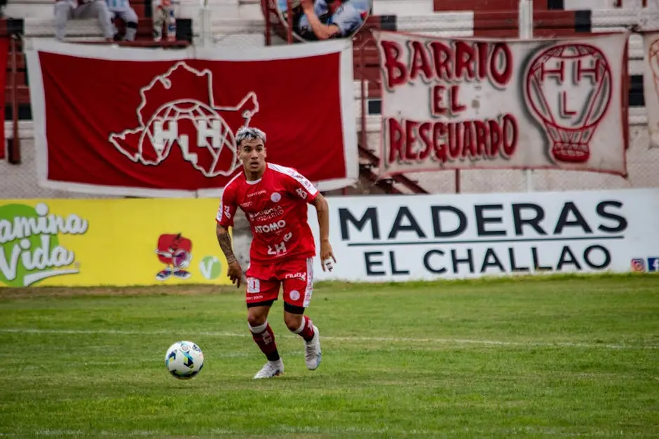 لاعب جناح بقميص أحمر يراوغ بالكرة في تشكيلة وندركيدز FC 26