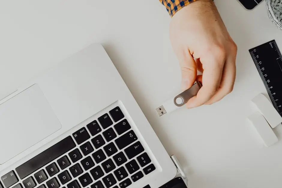 يد تركّب فلاشة USB في لابتوب لإنشاء فلاشة تثبيت ويندوز 11